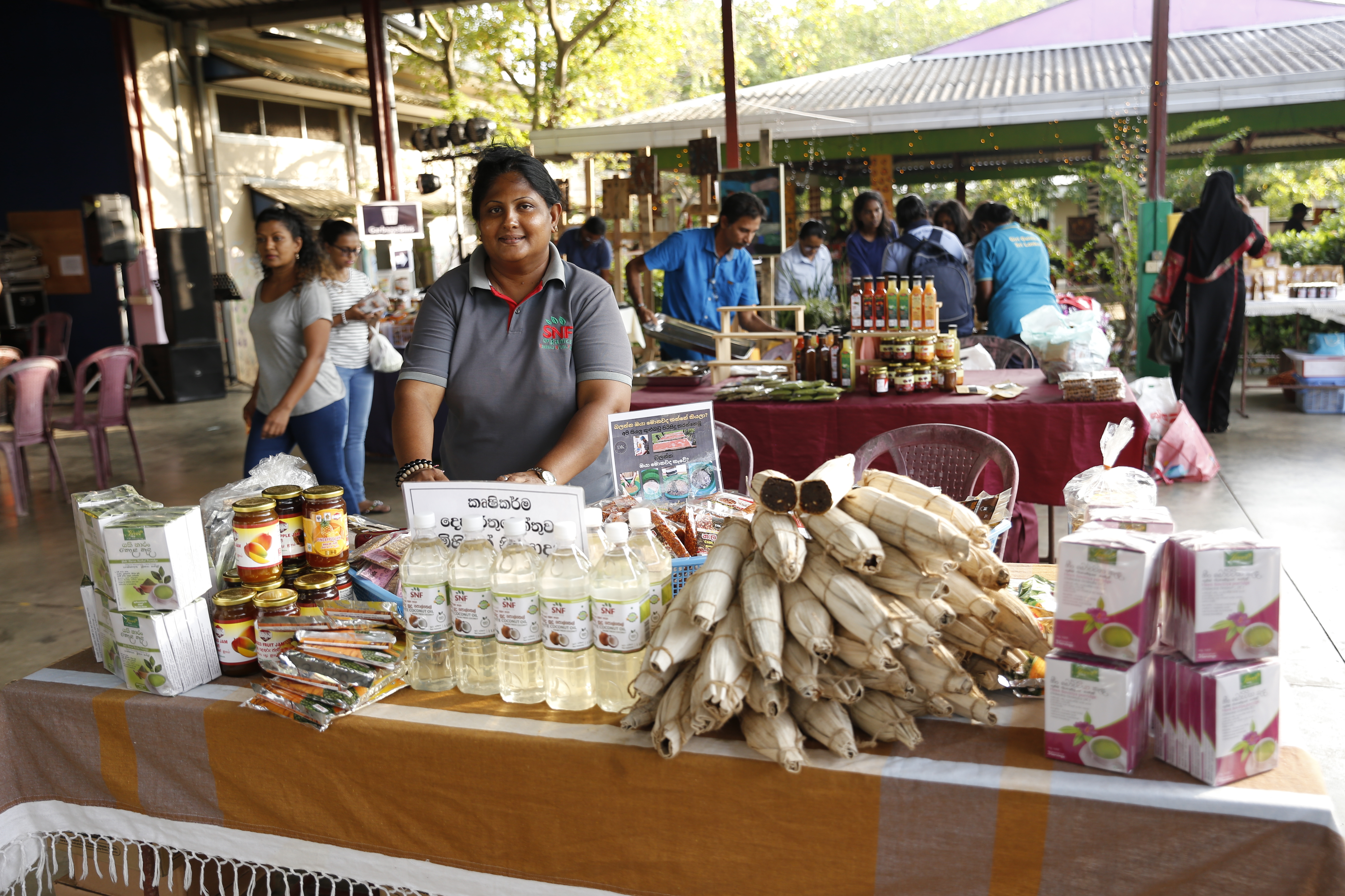 lady smiling at her stand at the People's Market